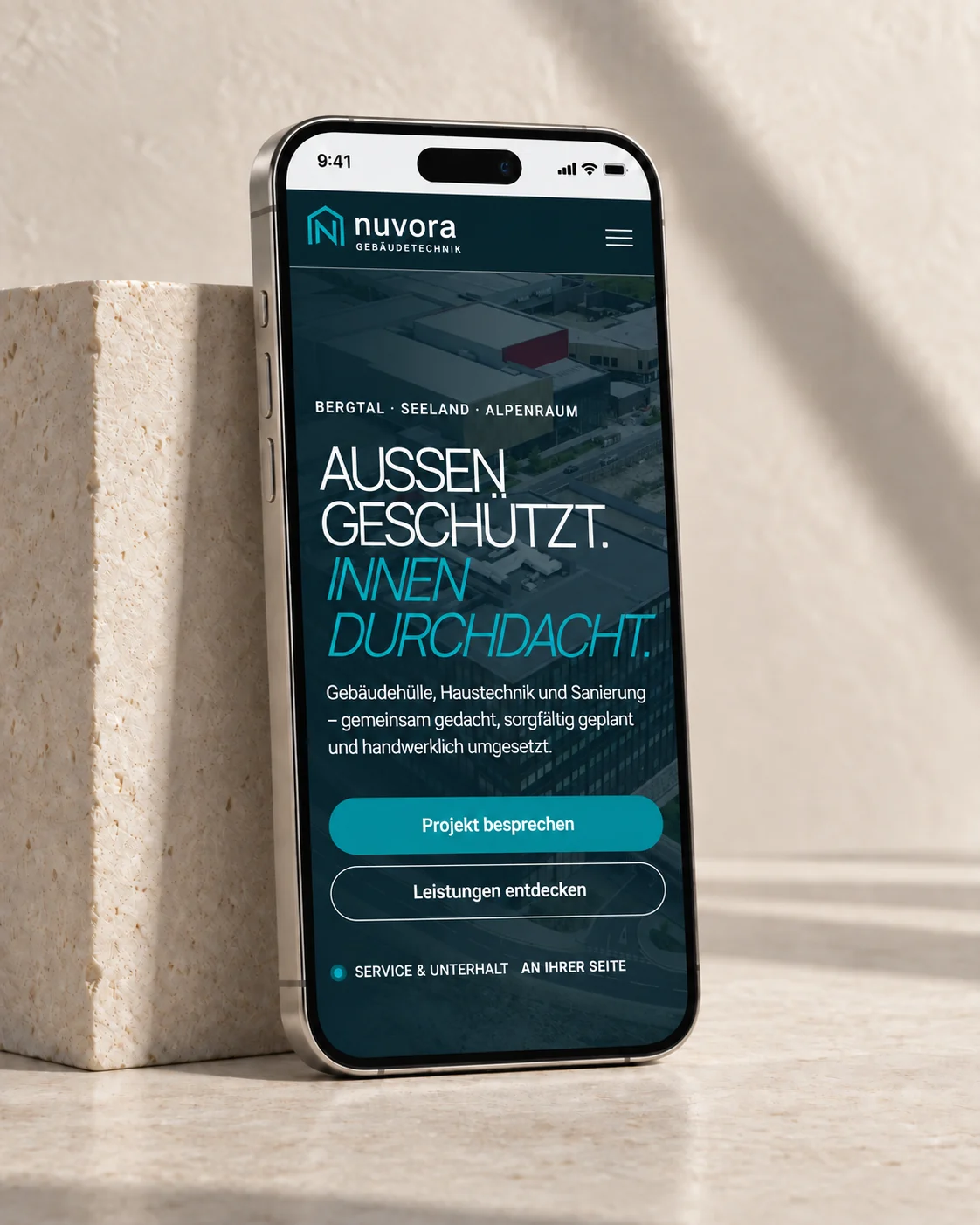 Mobile Nuvora-Website auf einem iPhone vor hellem Naturstein